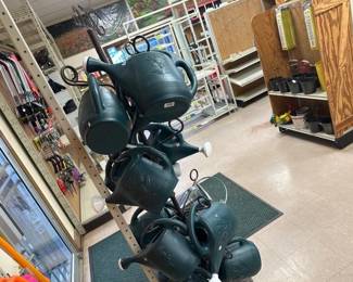 LOT OF WATERING CANS AND METAL STAND