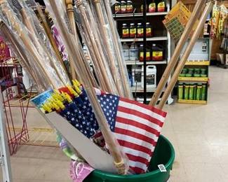 GARBAGE CAN, SMALL AMERICAN FLAGS, WOODEN FLAG POLES