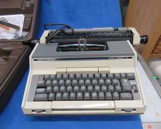 Lot 143. Smith-Corona Electric typewriter. Manual and 2 rolls of ribbon. Works