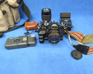 Lot 394. 35mm camera outfit including Revueflex AC2 camera, telephoto lens, light meter, flash, and case