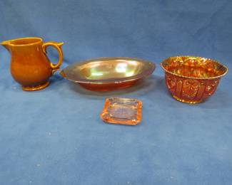 Lot 365. Two carnival glass bowls, a pink depression ashtray, and a McCoy pitcher. No chips or cracks.