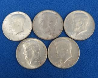 Lot 457. Five 1964 silver Kennedy half dollars