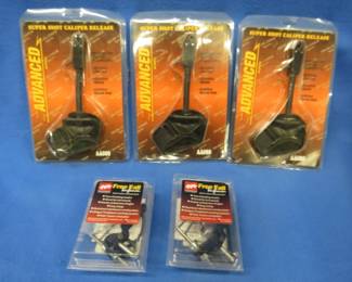 Lot 270. Five new-in-the-package archery items. Three caliper releases and two drop-away arrow rests.