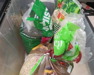 Lot 144. Three partial bags of bird seed