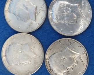 Lot 429. Four 1964 silver Kennedy half dollar coins