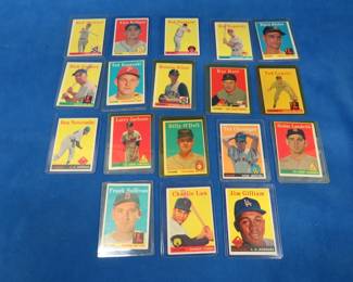 Lot 437. Eighteen 1958 Topps baseball cards. All are in plastic sleeves.