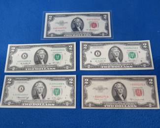 Lot 321. Five uncirculated $2.00 bills including a star note