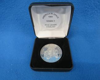 Lot 54. America in Space sterling silver medallion. Total coin weight 26.60 grams. Includes matching pamphlet.
