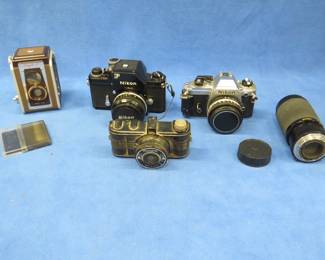 Lot 393. Two 35mm cameras and two older film cameras