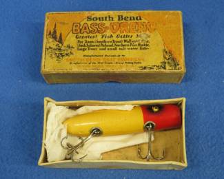 Lot 284. Vintage South Bend "Red Sky Box" and a wooden Bass-Oreno with glass eyes