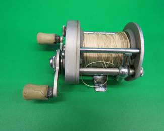 Lot 387. Vintage Pflueger Supreme baitcasting reel with oil and leather bag