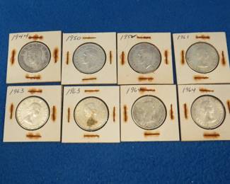 Lot 322. Eight silver Canadian half dollars. Dates range from 1944-1964.