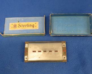 Lot 298. Sterling brand double-sided tremolo harmonica with brass reed plates in the keys of C and G in the box.
