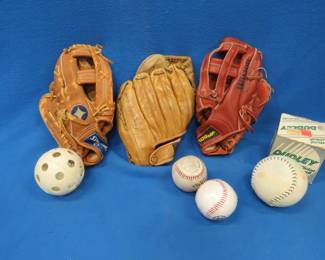 Lot 431. Softballs, hardballs, one LH and two RH baseball gloves.