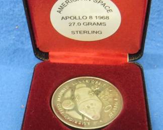 Lot 56. America in Space sterling silver medallion. Total coin weight 27.0 grams. Includes matching pamphlet.