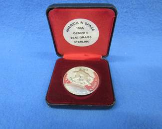 Lot 55. America in Space sterling silver medallion. Total coin weight 26.62 grams. Includes matching pamphlet.