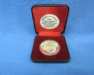 Lot 57. America in Space sterling silver medallion. Total coin weight 26.74 grams. Includes matching pamphlet.