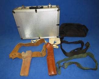 Lot 347. Two leather holsters, two nylon cartridge belts and an 18" x 13.5" x 6" metal case