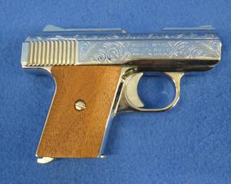 Lot 9. Raven Arms .25 semi-auto pistol. Ser. No. 1032910. Chrome-plated, wooden grips, and a velvet-lined case.