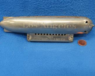 Lot 319. U.S.S. Los Angeles Graf Zeppelin souvenir "The Music master" harmonica made in saxony circa 1926. See our website for more condition info.