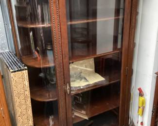 ANTIQUE WALNUT CURVED GLASS CURIO, AFRICAN COLONIAL FIGURE IN YELLOW SHIRT