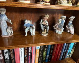 From left to right
*Lladro, Dear Santa #6166, retired
*Lladro, All Tuckered Out #5846
* Ardco or Homco figurine, specifically the "Old Shoe-Shine Man"
*Lladro, Sweet Scent #5221
* Lladró , Pretty and Prim #5554