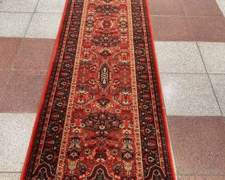 Red Runner Rug | Red runner rug with flourishing details. 