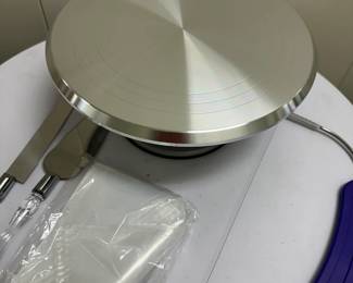 Rotating Cake Stand | Rotating cake stand for decorating (new in box) with piping bags and pie servers. - h. 5 x dia. 12 in (cake stand)

