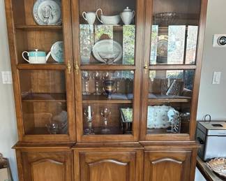 China Display Cabinet | Wooden triple cabinet with glass doors over lower cabinet doors.