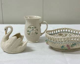 (3pc) Belleek Decor | Belleek snowman mug: 4.5 in.
Belleek ceramic basket: 7 in. x 5 in. x 2.5 in.
Swan (unmarked): 3 in.
