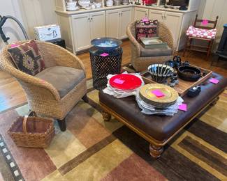 Pair of woven barrel chairs, rectangular ottoman, charges, pottery, wooden tray and area rug