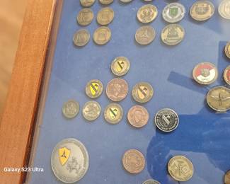 close up of coffee table with military coins, they will be sold with the table
