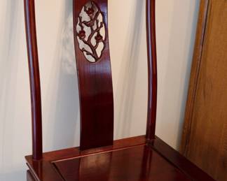 Detail of the Chinese style dining chairs with carved back slat