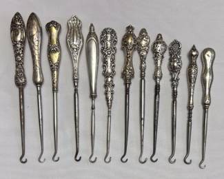 More antique sterling silver handled button hooks