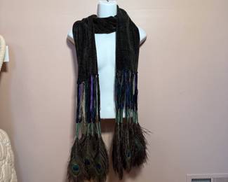 A velvety scarf with ribboned tassels of peacock feathers