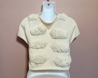 Back view of Anthropologie sweater - Short sleeve ivory shrug with padded decoration, snap front