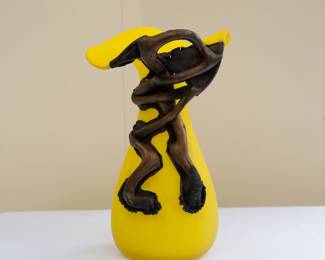 A stylized glass and applied metal vase