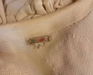 Closeup of Anthropologie sweater - Short sleeve ivory shrug with padded decoration, snap front