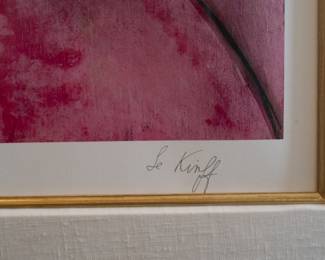 Closeup of framed signed color print of a woman, man, and cat, by artist Linda Le Kinff