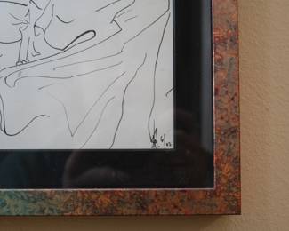 Closeup of signed ink drawing of a sleeping figure with a sleeping cat nestled in the blankets