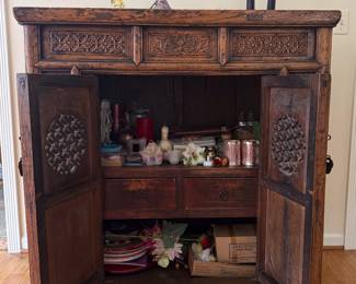 Interior of the antique carved Chinese cabinet with double doors, interior fitted with two compartments and two drawers