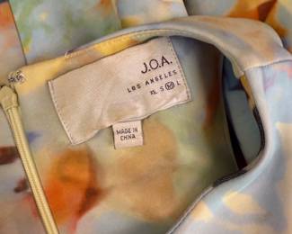 Closeup of J.O.A. Los Angeles sleeveless short dress, pastel abstract pattern, size M