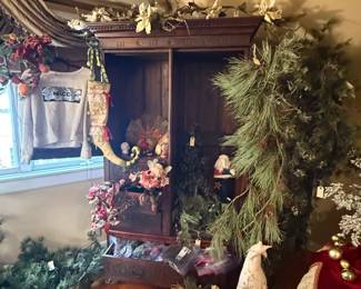 Christmas decorations and large wooden cupboard with drawers in base