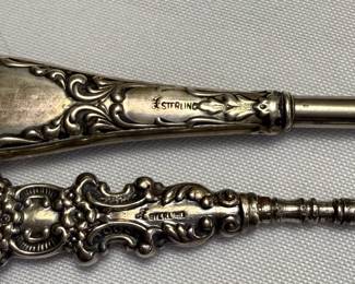 Closeup of the selection of antique sterling silver handled button hooks