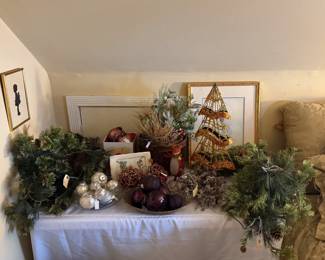 Holiday and Christmas themed decorations including wreaths, table top trees, glass ornaments