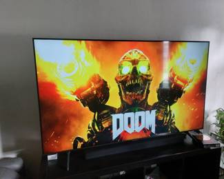 Large 64" Samsung smart TV with soundbar and subwoofer