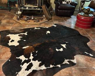 Large rug, leather recliner, vintage horse collar, games, saddle, ottoman with removable top