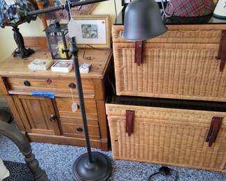 Antique cabinet, wicker trunks, Tiffany style lamp. Floor lamps.