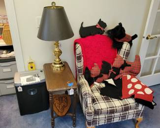 Custom upholstered wing back chair, scotty dog bits and pieces, antique side table, shredder, brass lamp.