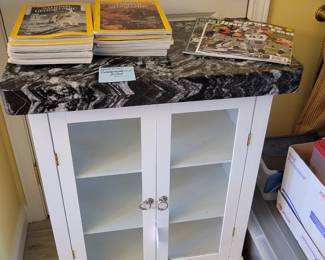Marble topped 2 door cabinet.